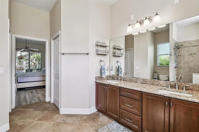 a spacious bathroom with a tub sink and mirror