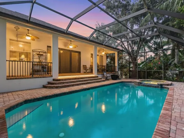 a swimming pool with outdoor seating and yard