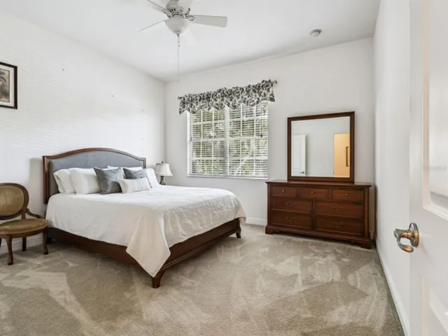 a bathroom with a granite countertop bathtub shower sink vanity mirror and toilet