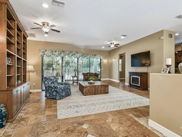 a living room with fireplace furniture and a flat screen tv