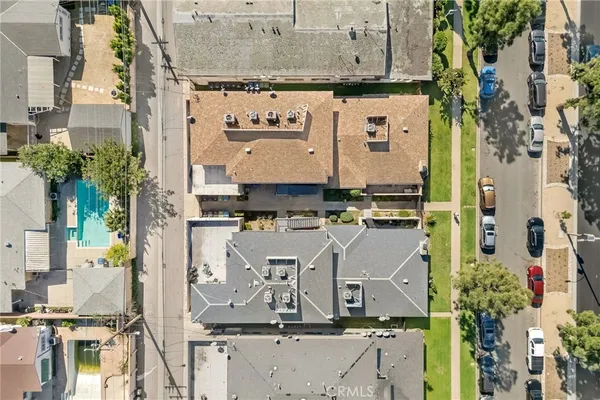 an aerial view of a residential apartment building with a yard