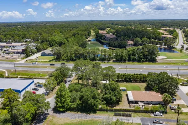 an aerial view of a house with a yard and lake view