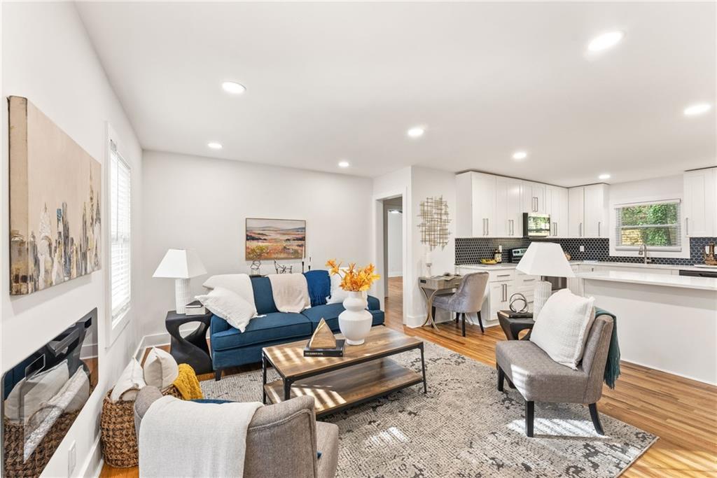 3372 Jackson Drive Decatur, GA 30032 - Photo 4 of 26 a living room with furniture kitchen view and a fireplace
