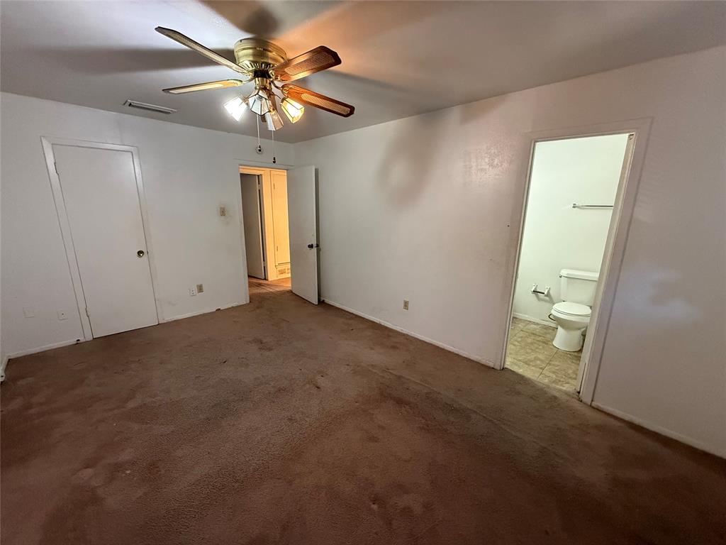 1334 Rutherford Drive Mesquite, TX 75149 - Photo 19 of 22 an empty room with closet and a chandelier fan