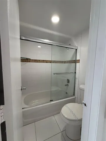 a bathroom with a toilet and shower