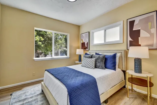 a bedroom with a bed and wooden floor