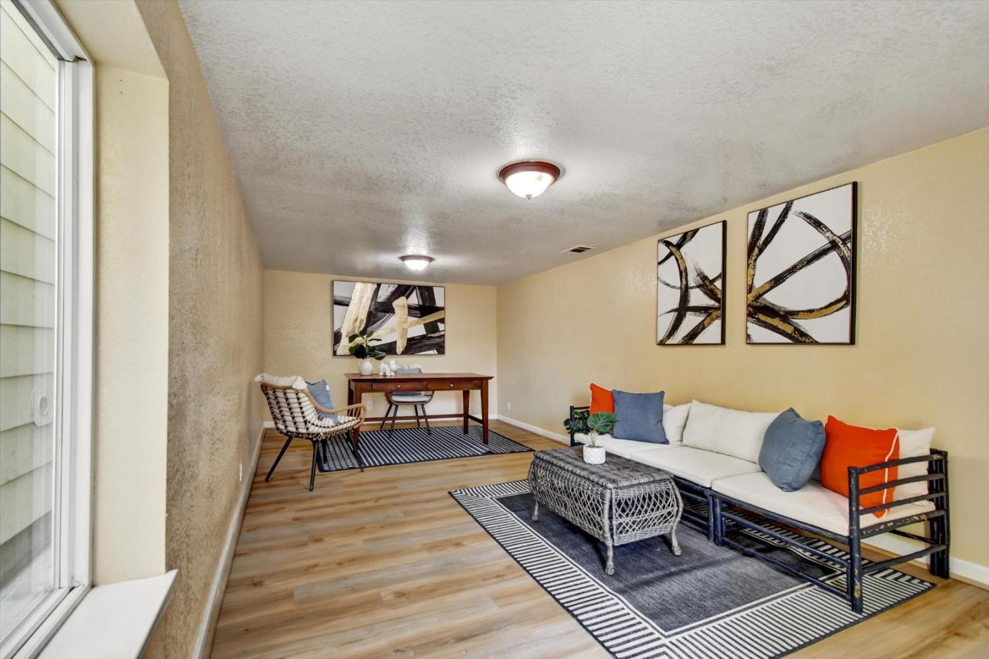 324 Holloway Avenue San Francisco, CA 94112 - Photo 18 of 37 a living room with furniture a rug and a wall painting