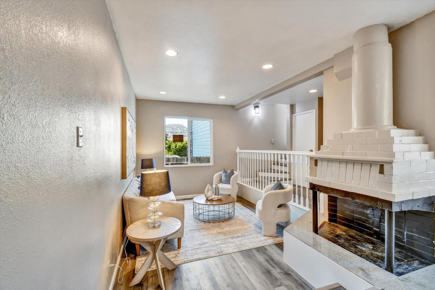 324 Holloway Avenue San Francisco, CA 94112 - Photo 25 of 37 a living room with furniture and a fireplace
