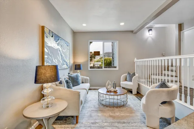 a living room with furniture fireplace and a painting on the wall
