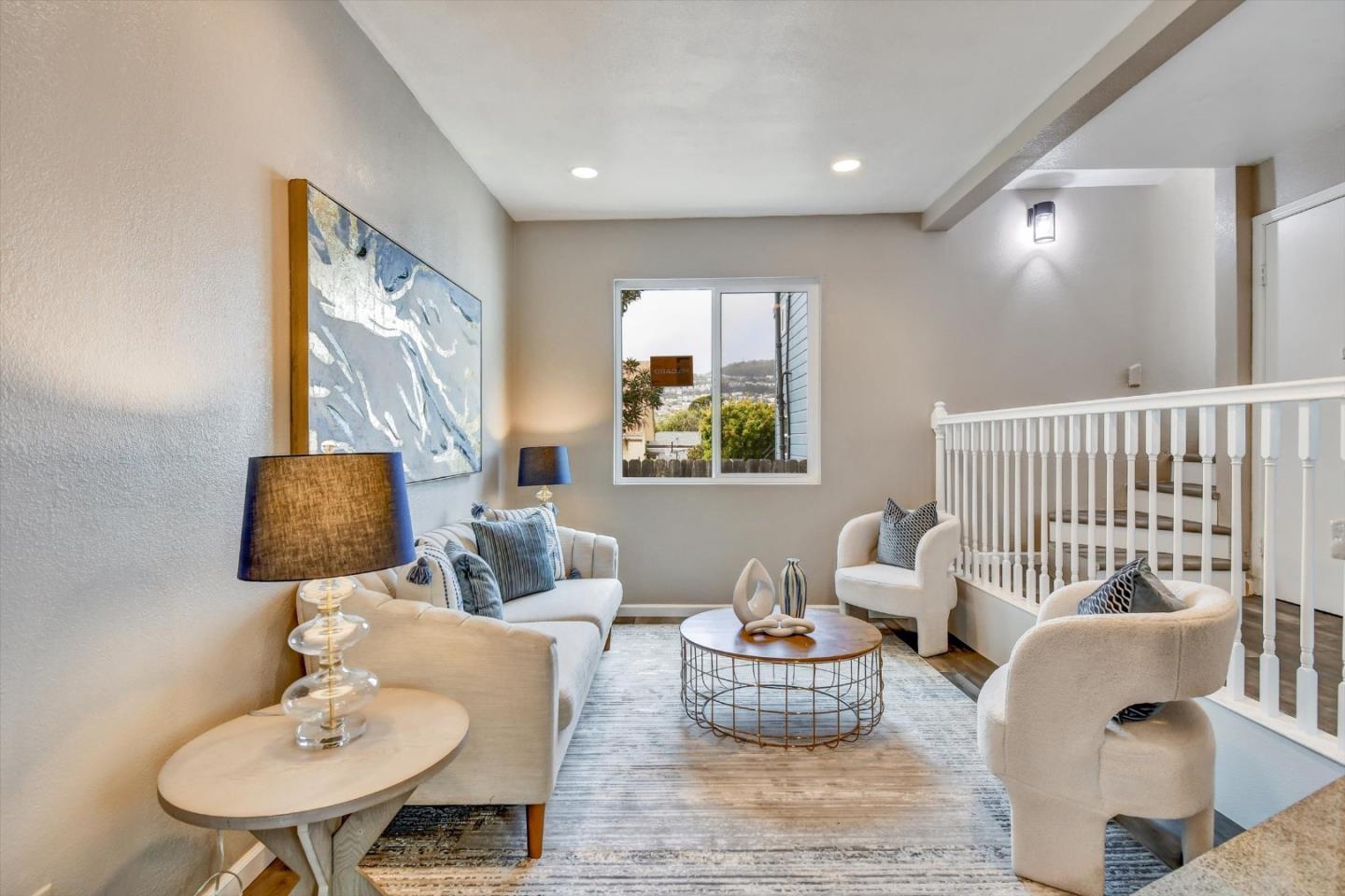 324 Holloway Avenue San Francisco, CA 94112 - Photo 26 of 37 a living room with furniture and a lamp