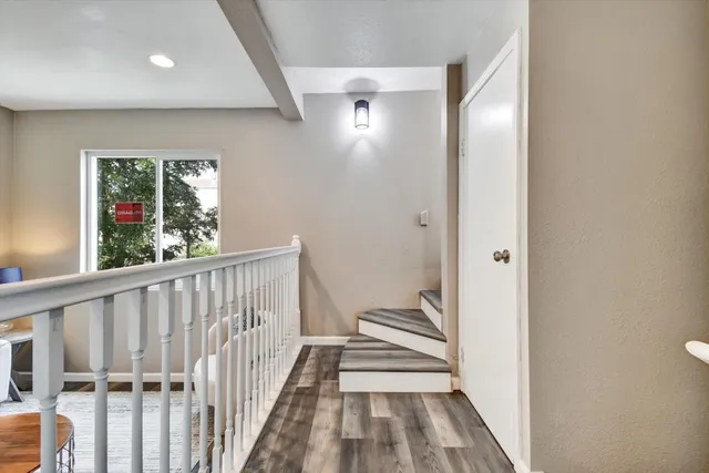 a view of a hallway with furniture