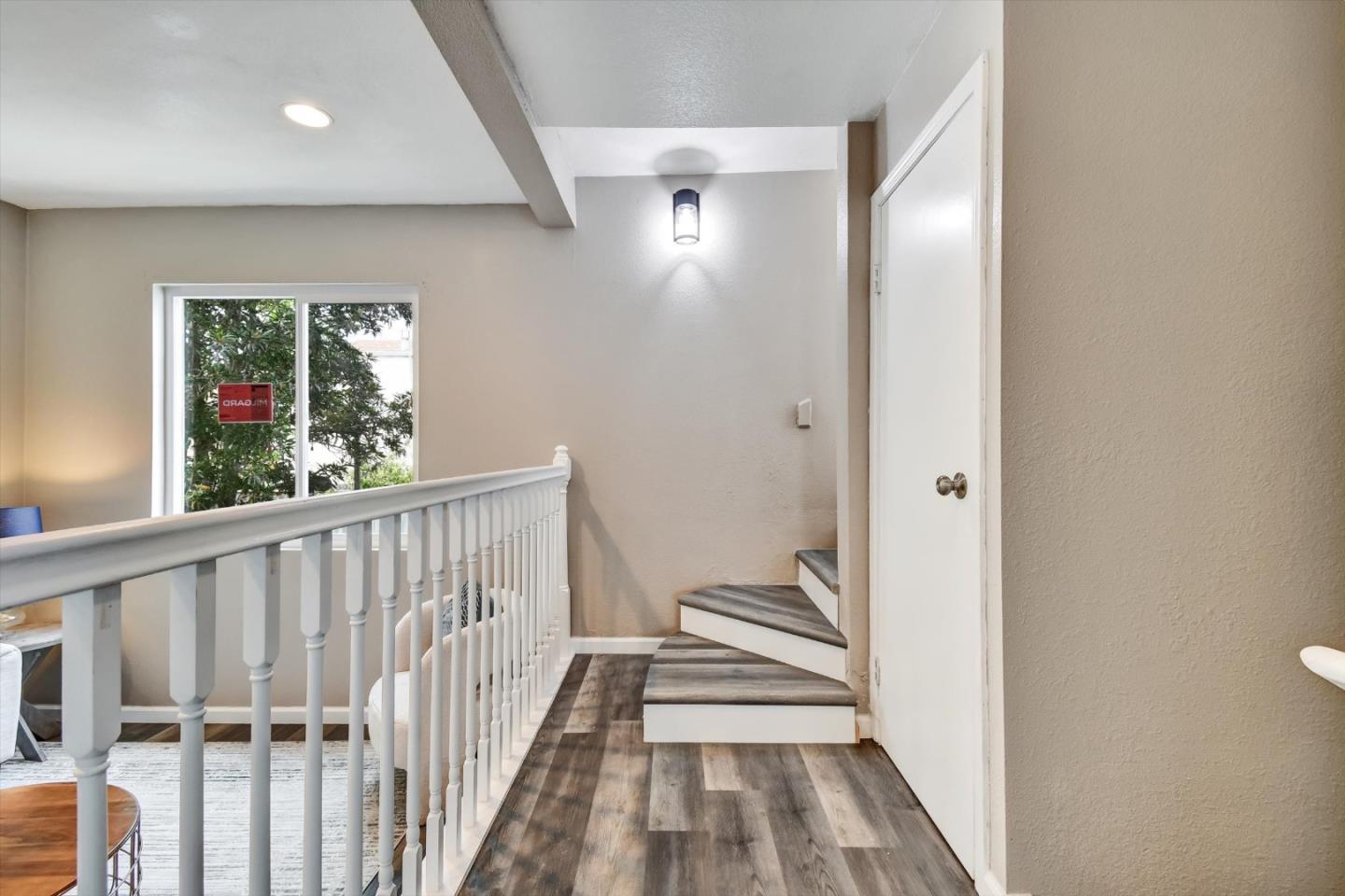 324 Holloway Avenue San Francisco, CA 94112 - Photo 32 of 37 a view of a hallway with wooden floor and a bathroom