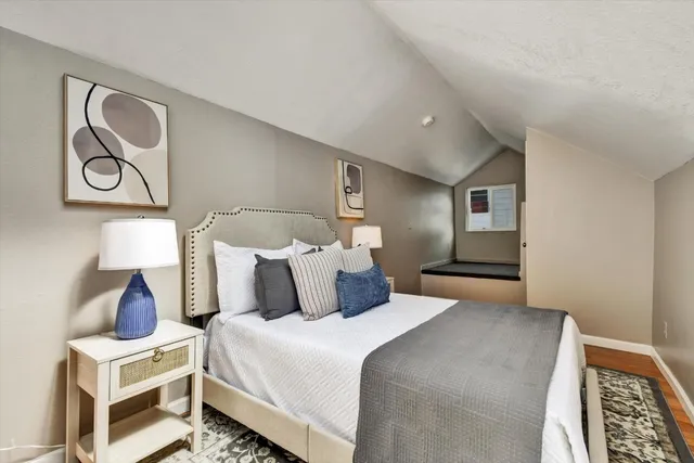 a view of a hallway with wooden floor and furniture