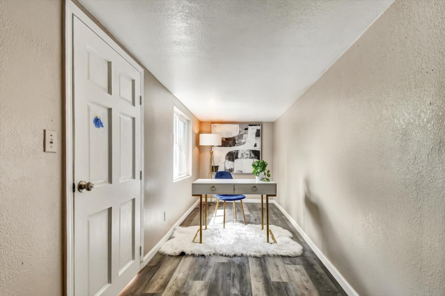 324 Holloway Avenue San Francisco, CA 94112 - Photo 35 of 37 a view of a hallway with wooden floor and furniture