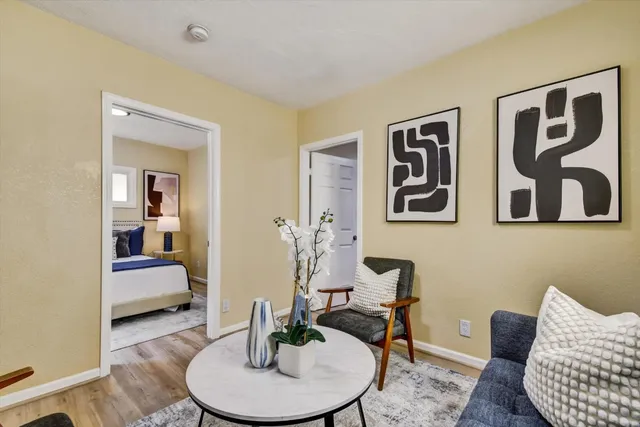 a living room with furniture and painting