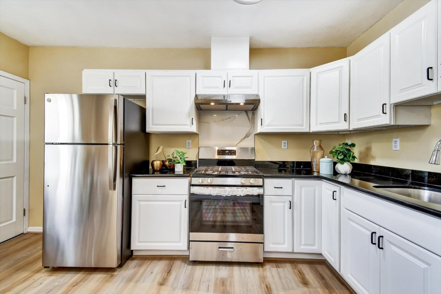 324 Holloway Avenue San Francisco, CA 94112 - Photo 8 of 37 a kitchen with a white cabinets and white appliances