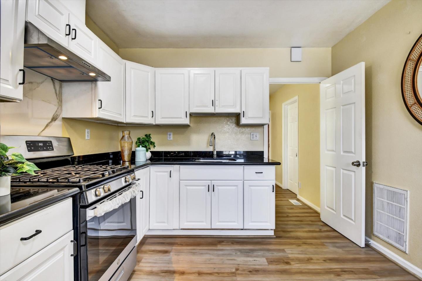 324 Holloway Avenue San Francisco, CA 94112 - Photo 9 of 37 a kitchen with stainless steel appliances granite countertop a stove a sink and a refrigerator