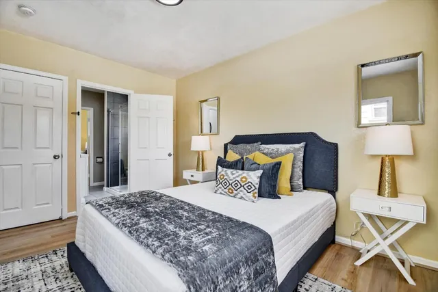 a bedroom with a bed and a lamp on table