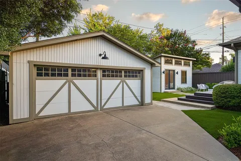 a view of a house with a yard and garage