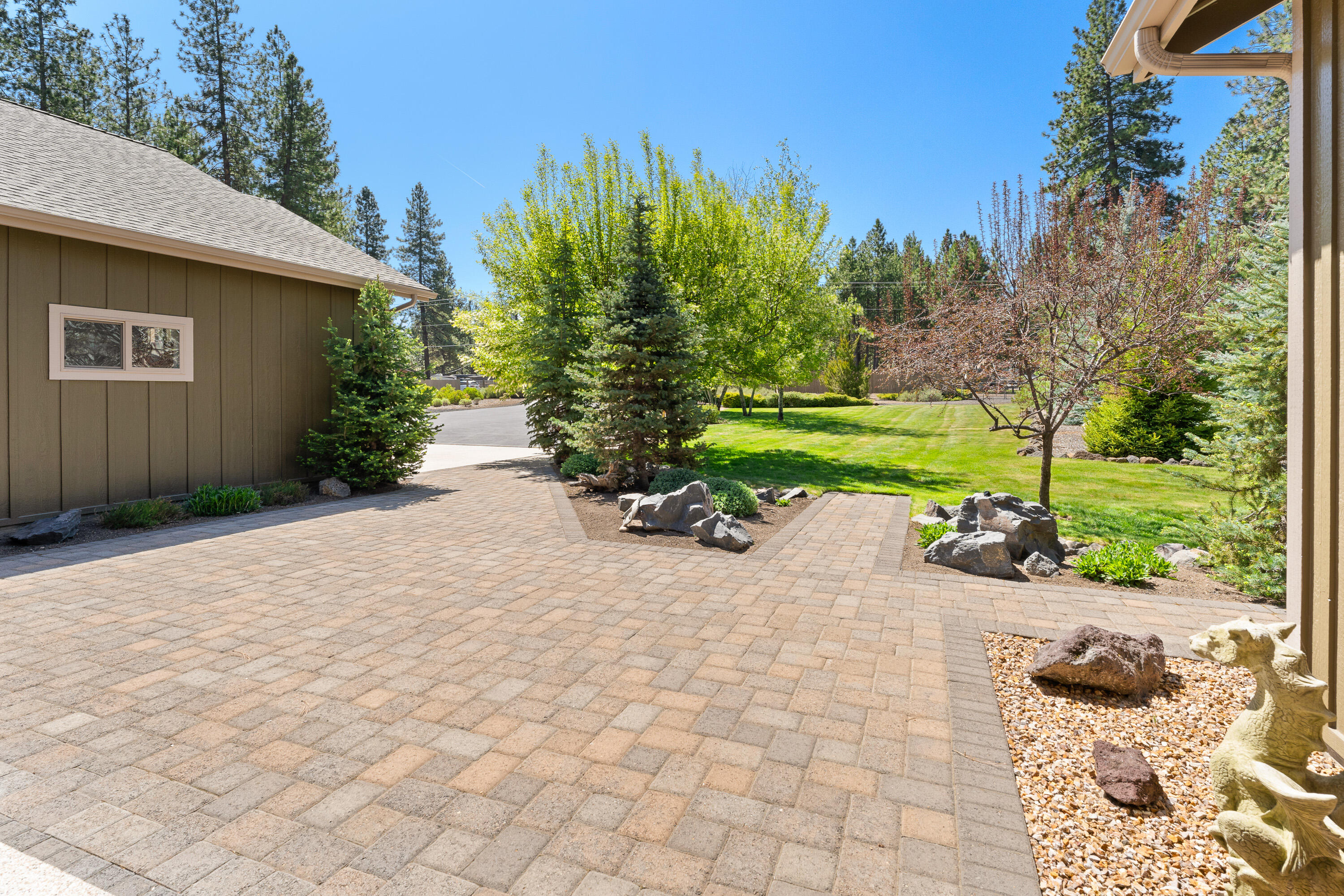 19236 Kiowa Road Bend, OR 97702 - Photo 6 of 52 a view of a backyard with plants and a patio