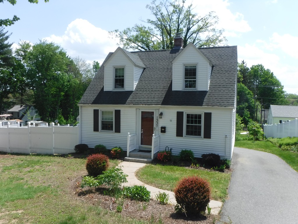 1337 Sumner Avenue Springfield, MA 01118 - Photo 1 of 30 a front view of a house with a yard and garage