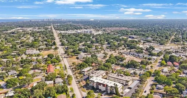 an aerial view of residential building with green space