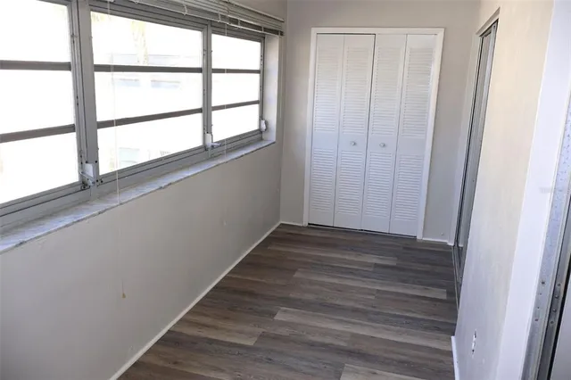 a view of wooden floor and windows in a room