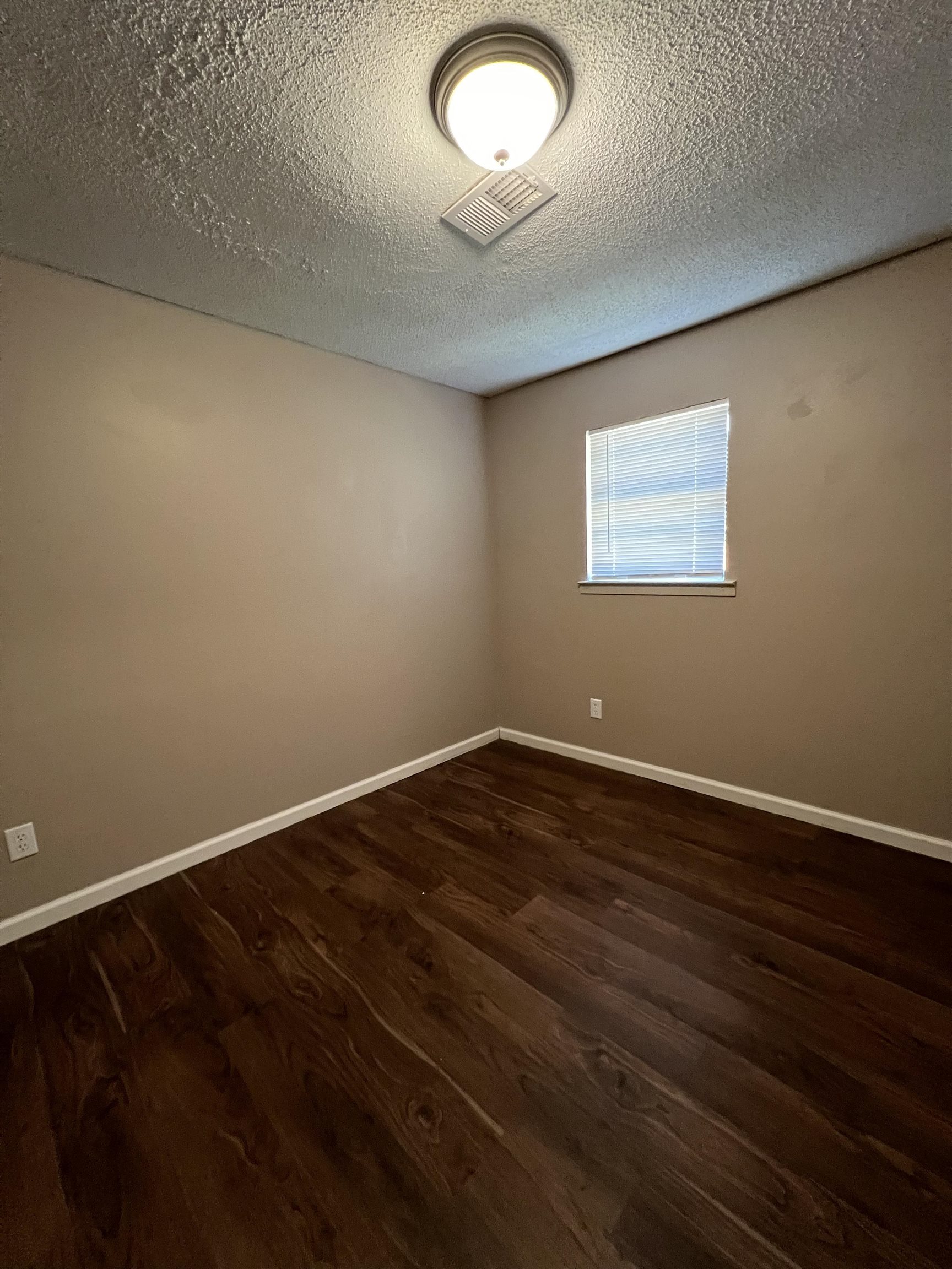 794 Nonconnah Road Memphis, TN 38109 - Photo 5 of 6 Wood-finish flooring with neutral wall tones and a window with blinds
