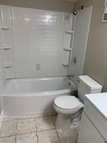 a bathroom with a toilet and shower