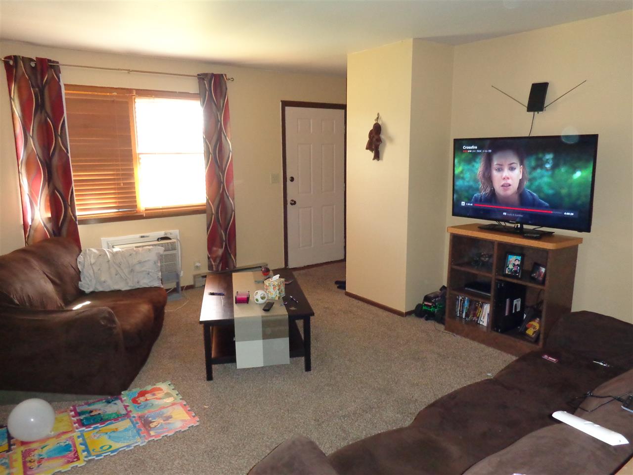 10039 Bitterroot Road Roscoe, IL 61073 - Photo 8 of 14 a living room with furniture and a flat screen tv