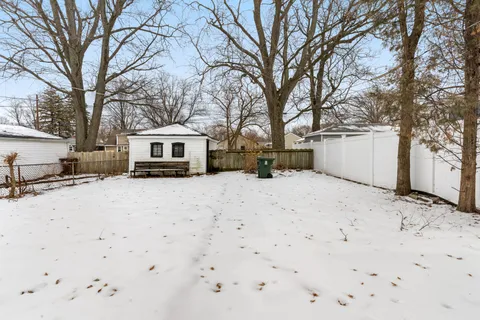 a front view of a house with a yard covered with snow in front of house