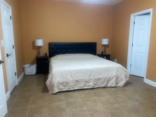 a bedroom with a bed and night stand