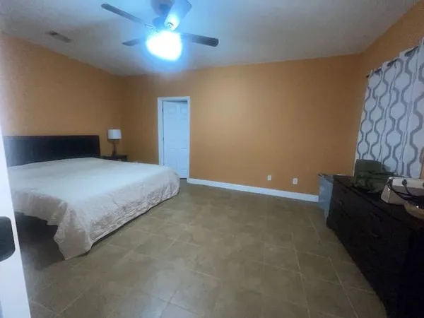 a bedroom with a bed and a lamp