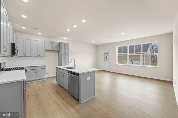 a kitchen with stainless steel appliances granite countertop a stove and a sink
