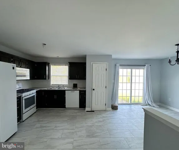 a kitchen with stainless steel appliances granite countertop a stove and a refrigerator