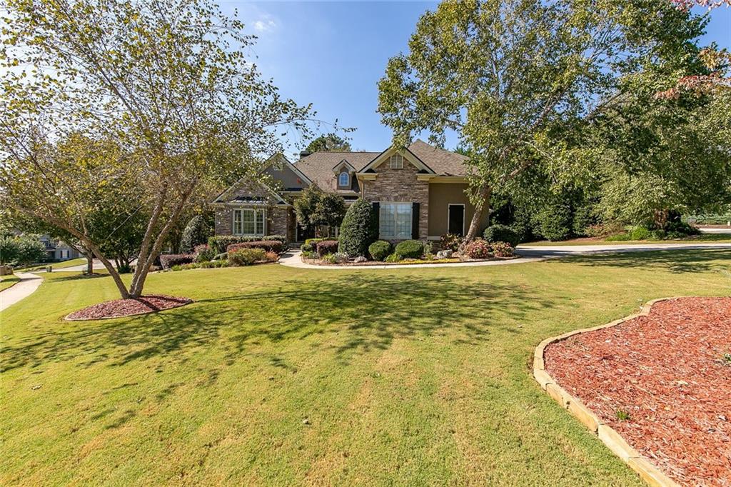 915 Gold Ridge Crossing Canton, GA 30114 - Photo 1 of 1 a view of a swimming pool with a house in the background