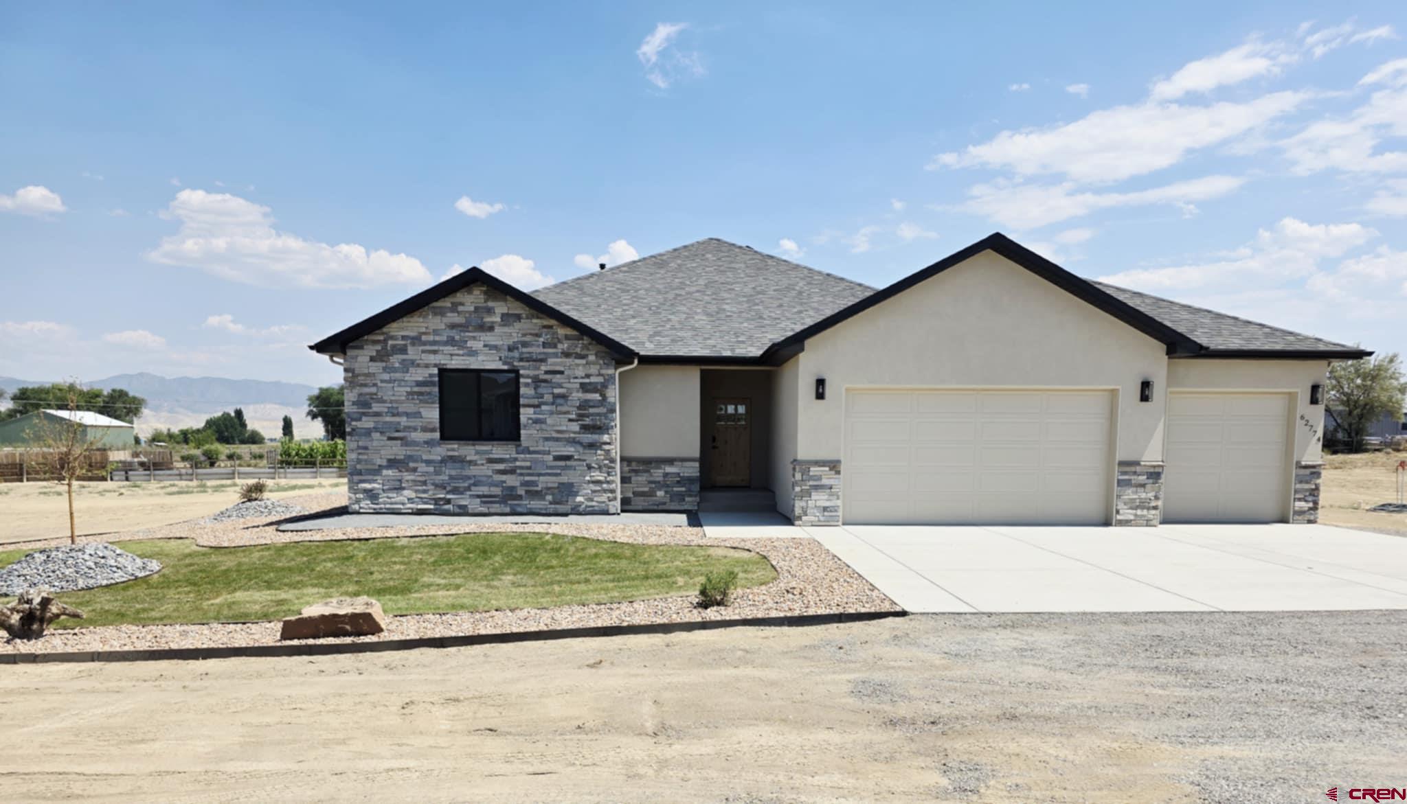 62774 Jacob Road Montrose, CO 81401 - Photo 1 of 35 a front view of a house with a yard