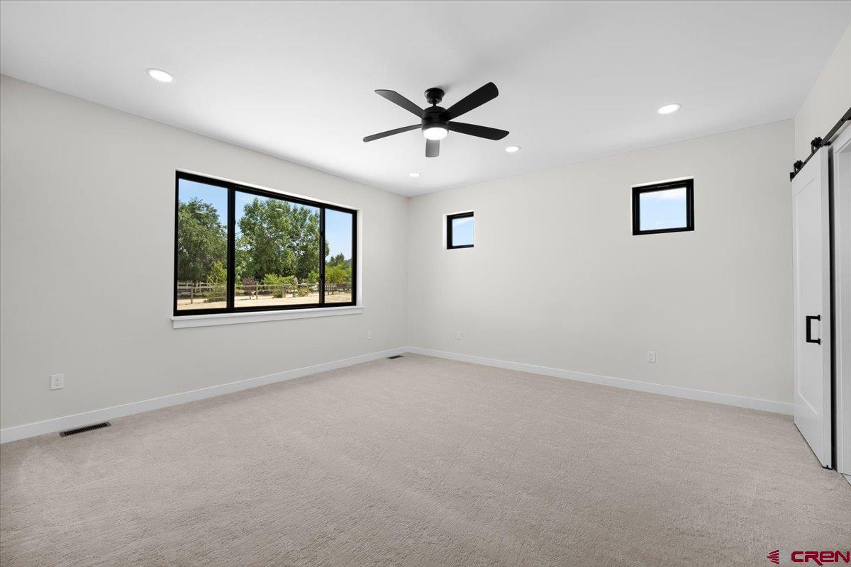 62774 Jacob Road Montrose, CO 81401 - Photo 16 of 35 wooden floor in an empty room with a window