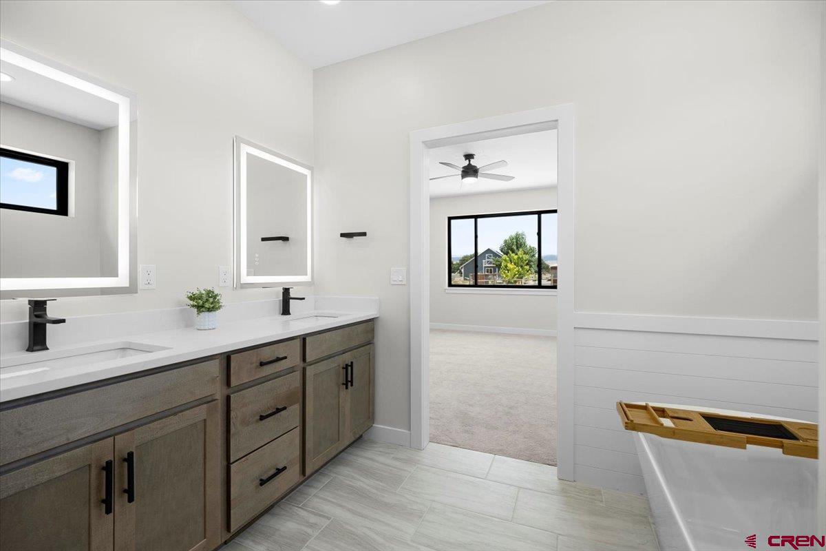 62774 Jacob Road Montrose, CO 81401 - Photo 22 of 35 a spacious bathroom with a double vanity sink and a window