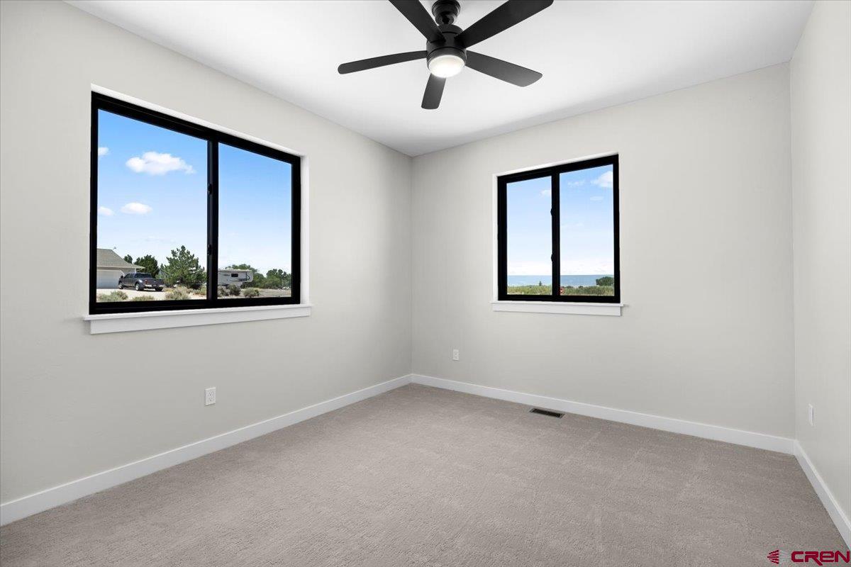 62774 Jacob Road Montrose, CO 81401 - Photo 25 of 35 an empty room with a window and a ceiling fan