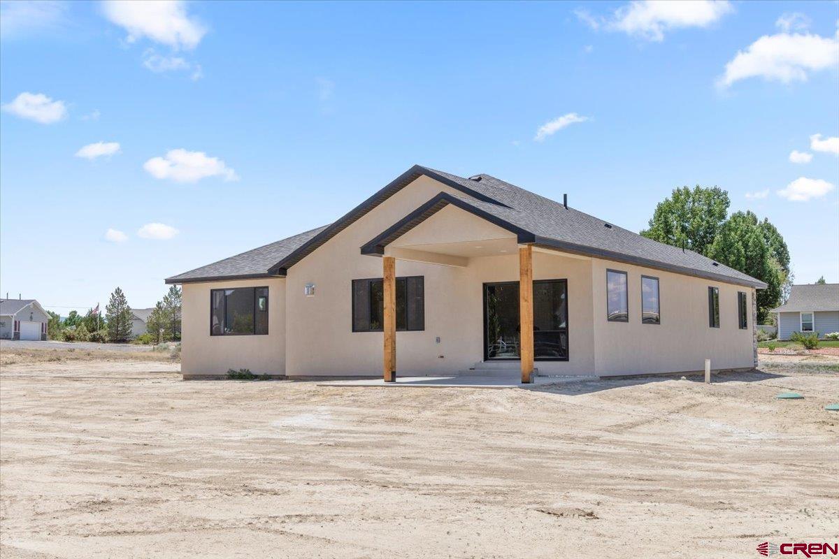 62774 Jacob Road Montrose, CO 81401 - Photo 32 of 35 a view of house with backyard and trees