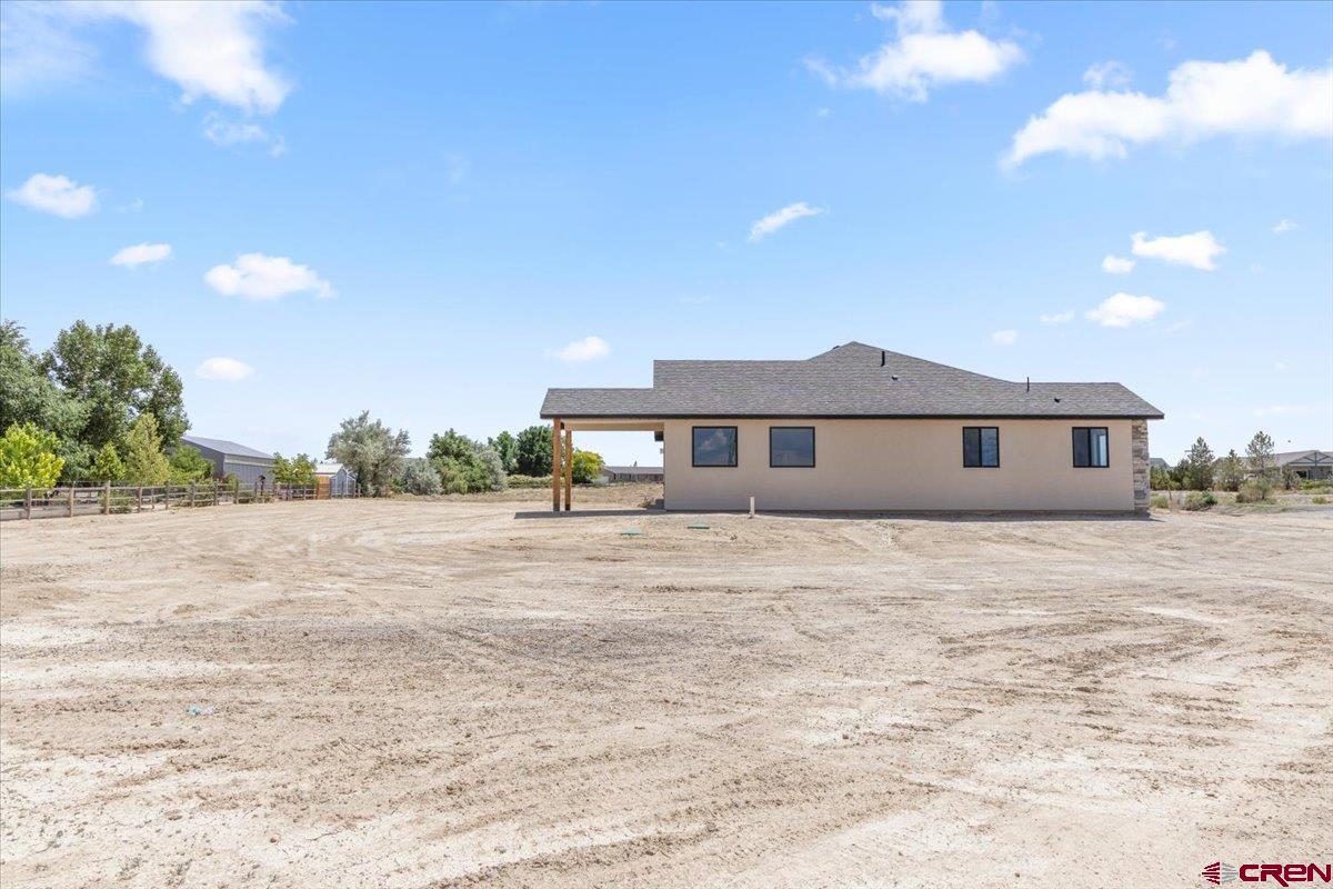 62774 Jacob Road Montrose, CO 81401 - Photo 33 of 35 a front view of a house with a yard