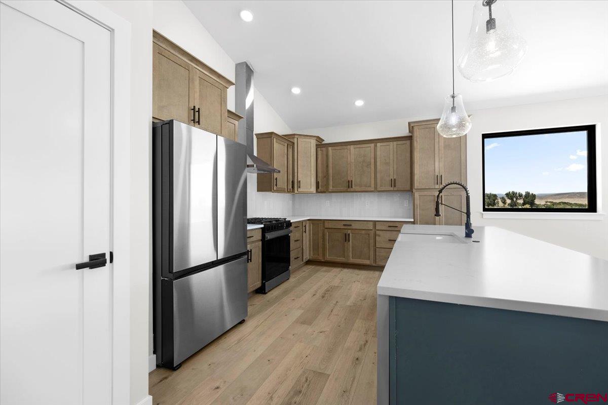 62774 Jacob Road Montrose, CO 81401 - Photo 10 of 35 a kitchen with kitchen island a sink appliances and cabinets