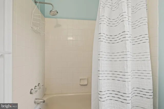 a bathroom with a bathtub and shower