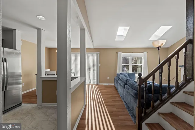 a view of a hallway with wooden floor and staircase