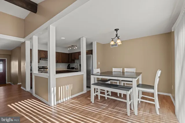 a view of a room with wooden floor furniture and windows