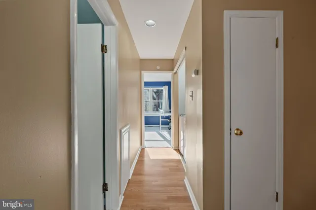 a view of a hallway with wooden shelves