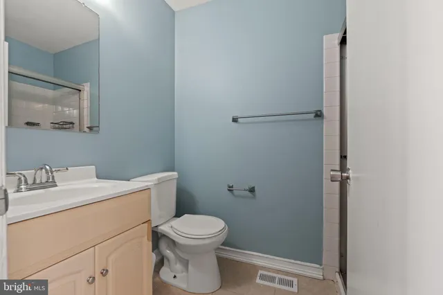 a bathroom with a toilet sink and vanity