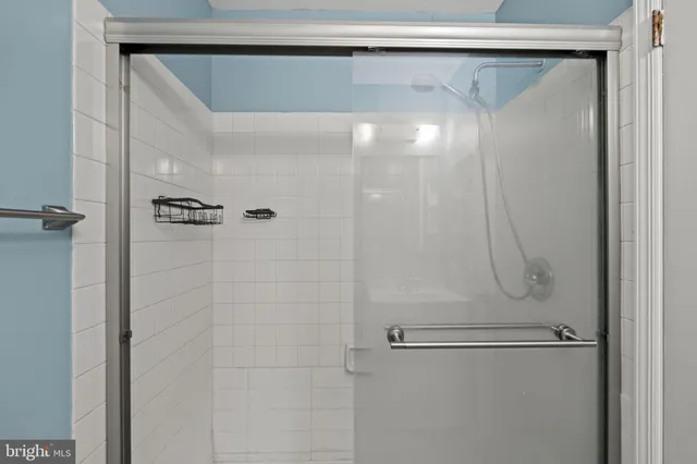 a bathroom with a glass shower door