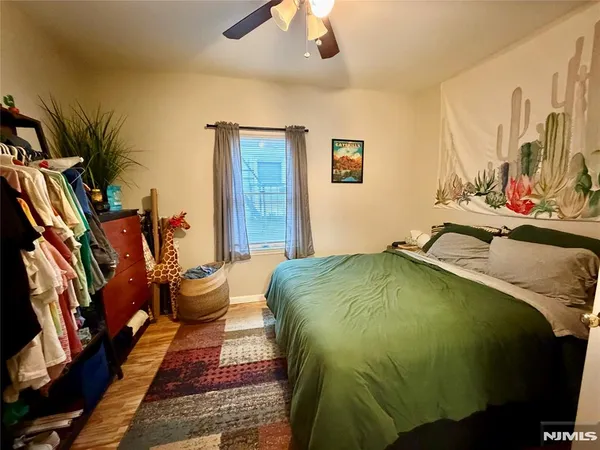 a bed sitting in a bedroom next to a window
